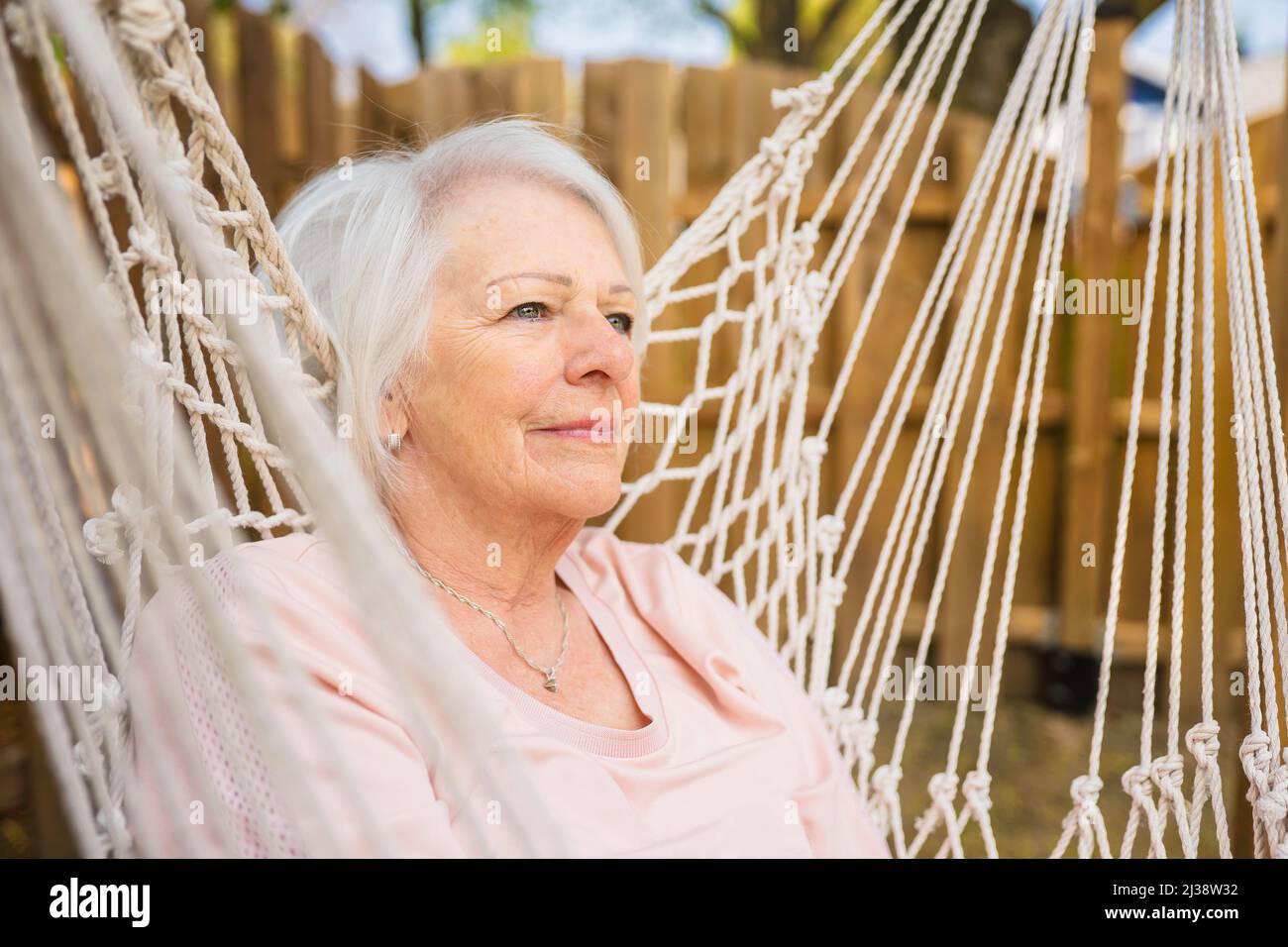 The senior woman relaxing in a hammock Stock Photo - Alamy