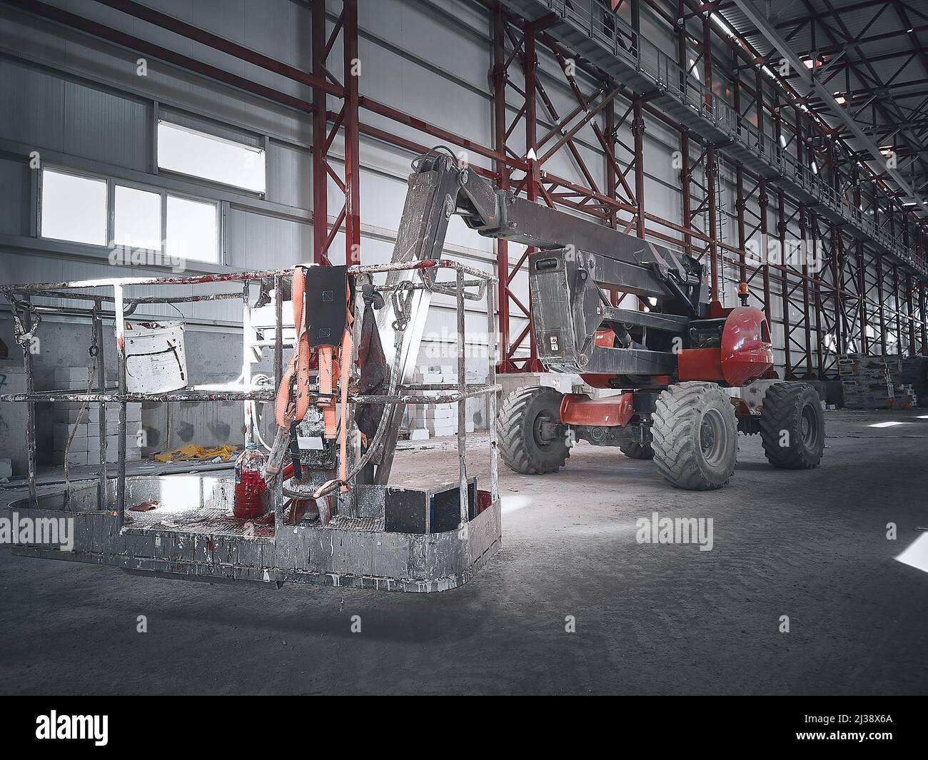 Basket of boom lift picker inside industrial building Stock Photo - Alamy