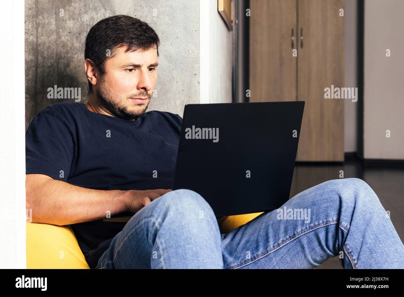 Man sitting on bean bag hi-res stock photography and images - Alamy