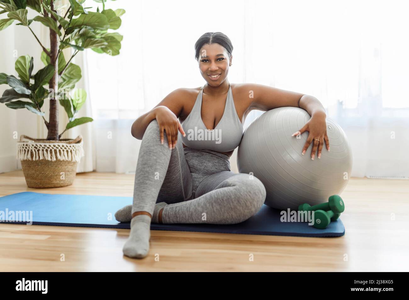 African american woman working out in home livingroom gym Stock Photo