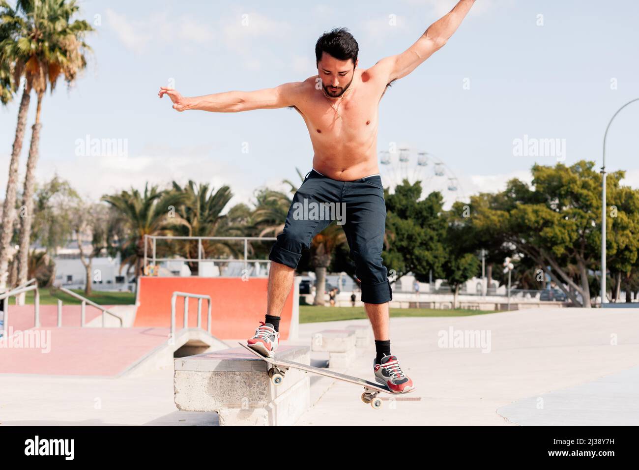 Boy doing skateboard trick on rail Stock Photo Alamy