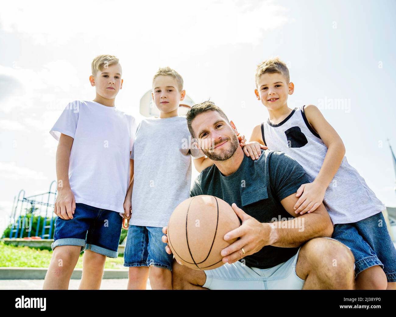 Happy basketball family portrait play this sport on summer season. The