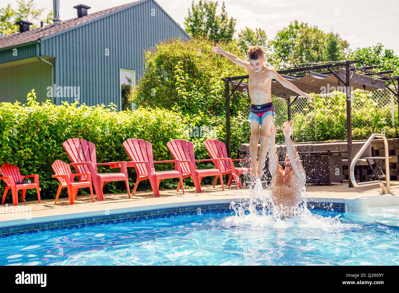 Father and son having fun in swimming pool Stock Photo Alamy