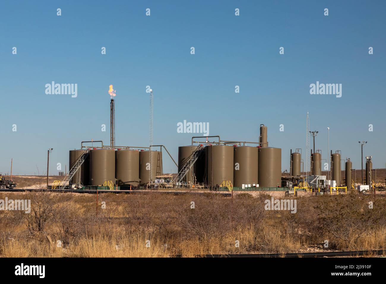 Loving, New Mexico Oil storage tanks and a gas flare in the Permian