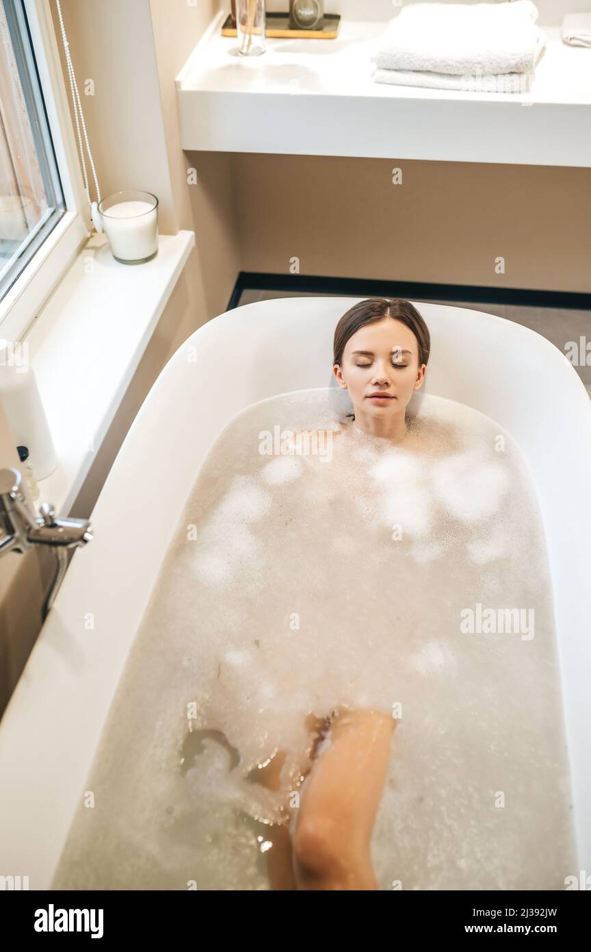 Attractive young woman sleeping in the bath Stock Photo Alamy