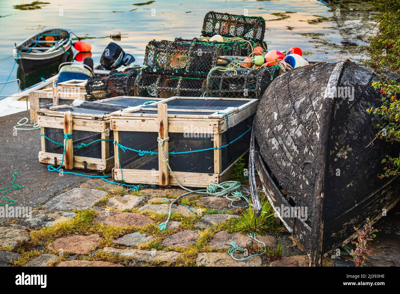 Old boat and fishing gear at Roundstone harbour, Connemara, County Galway, Ireland. Stock Photo