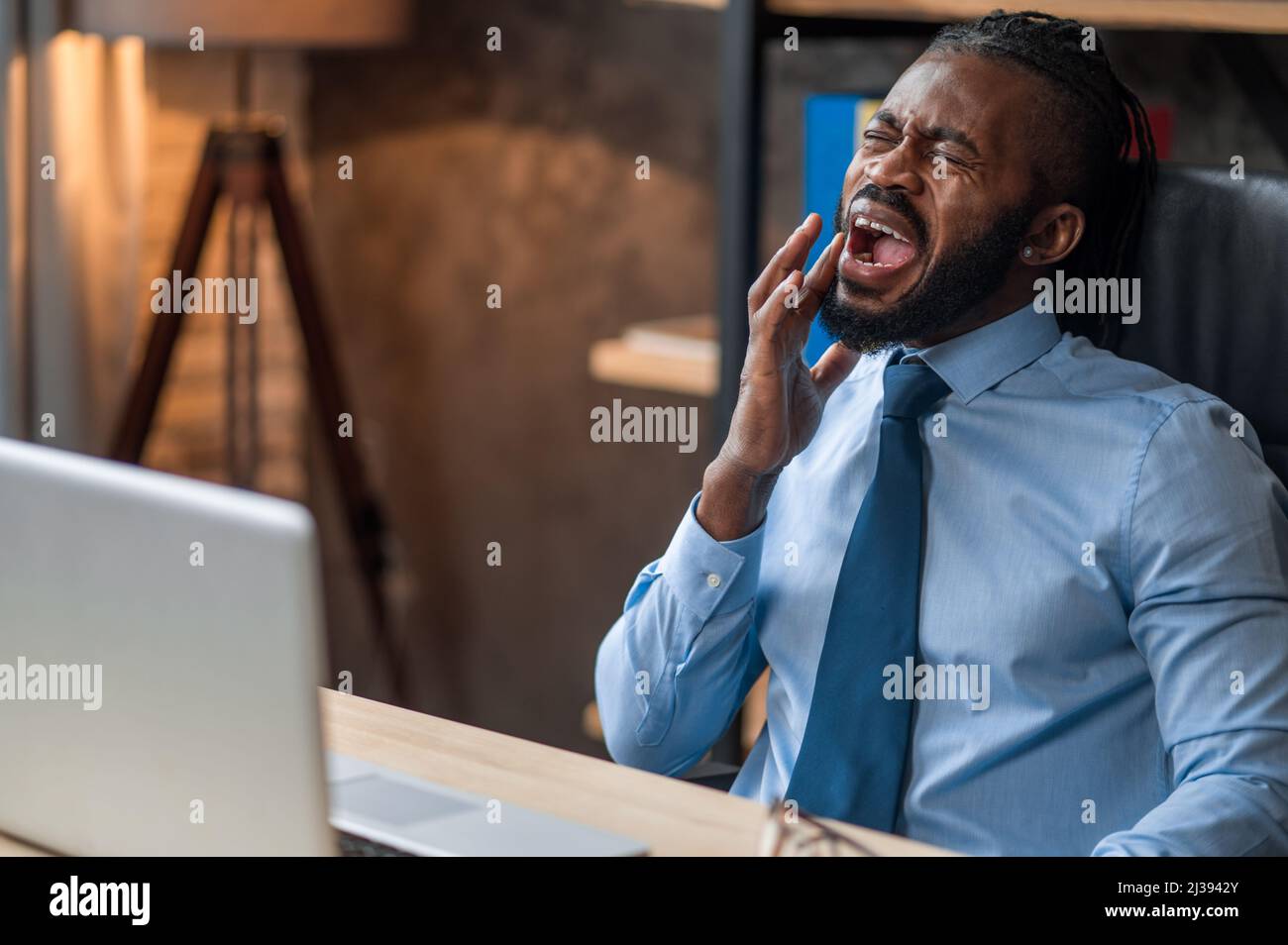 Young office worker having a severe toothache Stock Photo