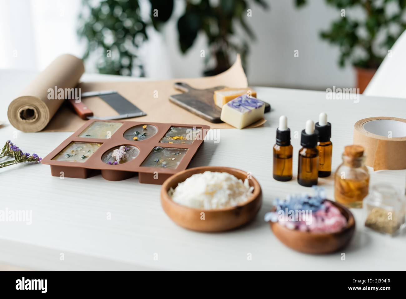 Soap making at home. Liquid glycerin with the additives of peels and flower  buds poured into a mould, with essential oils Stock Photo - Alamy