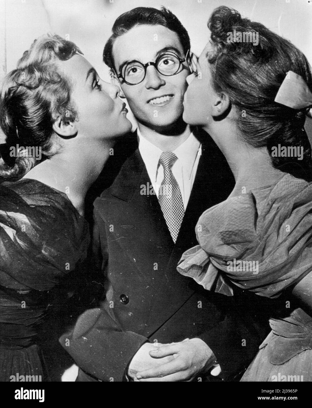 Harold Lloyd, Jr., Make Movie Debut -- Wearing a pair of cheap, glassless, horn-rimmed specs which his famed father wore nearly 30 years ago, Harold Lloyd, Jr., makes his debut as a movie actor. Harold, Jr., who is 18, has been studying dramatics for several years and has appeared in a few school plays. Phyllis Kirk is at left; Joan Evans at right. Young Lloyd has a small part in the picture, 'With All My Love.' September 12, 1949. (Photo by AP Wirephoto). Stock Photo