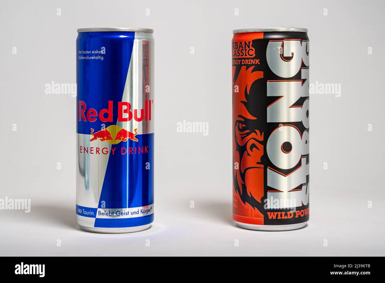 Red Bull energy drink versus Lidl store brand Kong Strong. Beverages with sugar as competition in the supermarket. Cheap alternative. Stock Photo