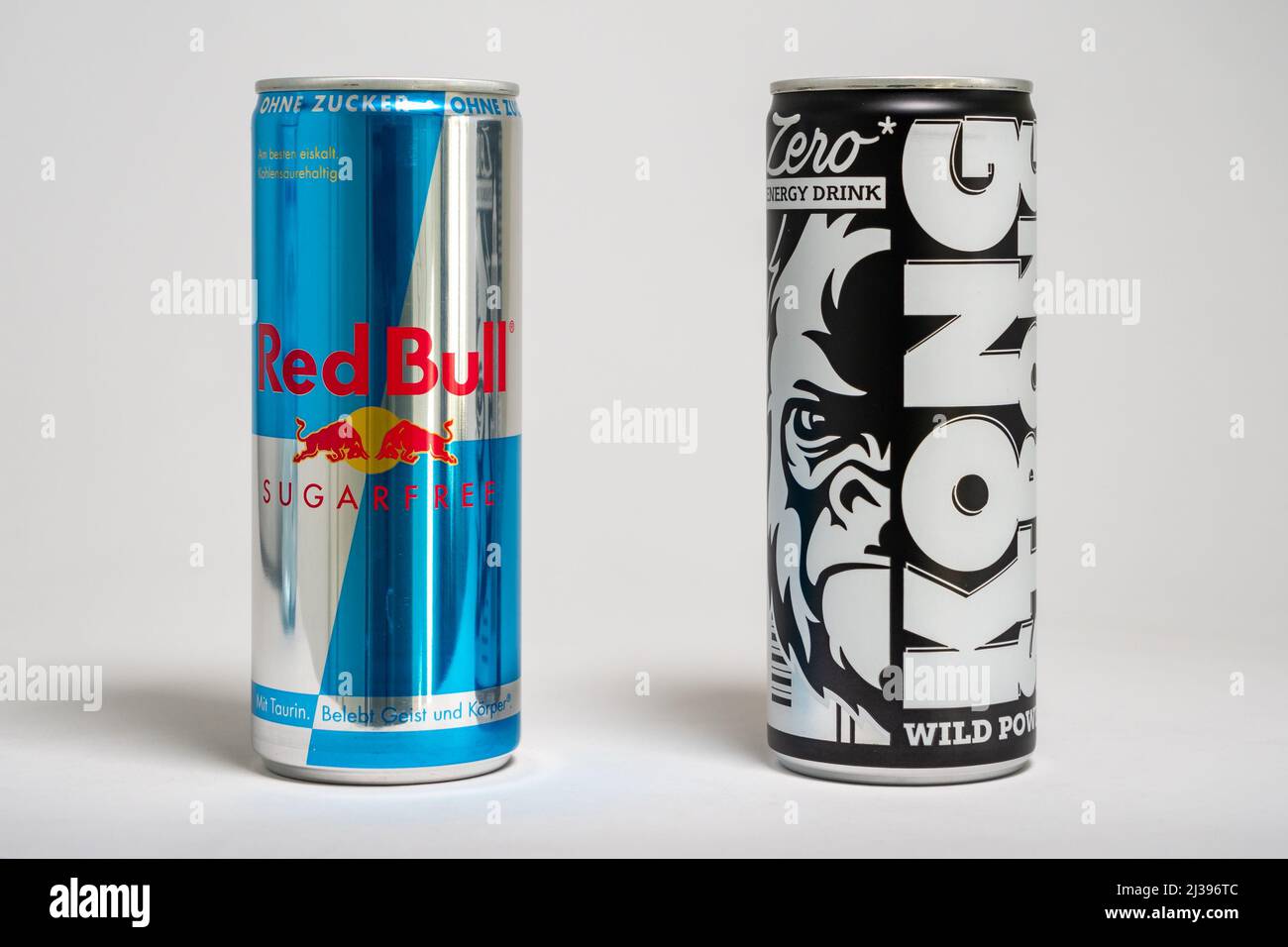 Red Bull sugar free energy drink versus Lidl store brand Kong Strong. Beverages as competition in the supermarket. Cheap alternative. Stock Photo