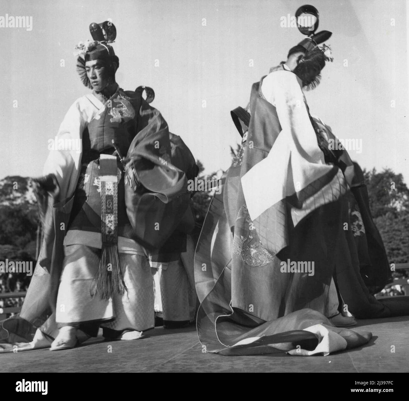 Exclusive Entertainment -- A feature of the Bugaku, an exclusive form of Japanese entertainment, is the imperial dance a scene from which is shown here. Only members of the Japanese royal family and high ranking officials had been privileged to witness this show. But precedent was broken recently when members of the allied forces and civilian personnel were invited to see the performance at the Imperial Gardens, the Royal family's agriculture reserve. November 11, 1946. (Photo by Wide World Photos). Stock Photo