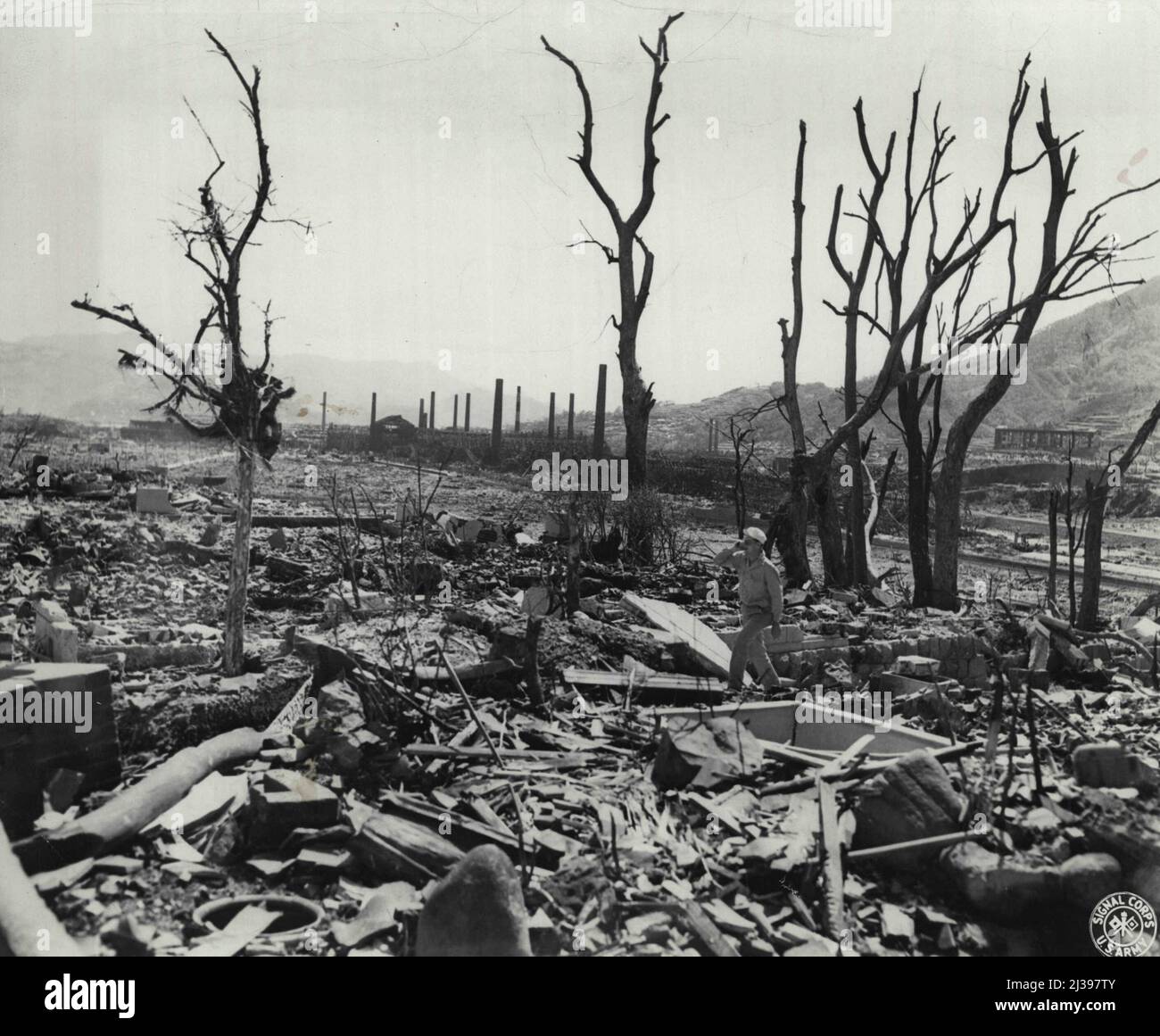 Top: Fat Man - the Plutonium-core atomic bomb which was exploded over Nagasaki. Above: The tortured remains of trees and rubble after the blast. October 09, 1945. (Photo by US Signal Corps Photo). Stock Photo