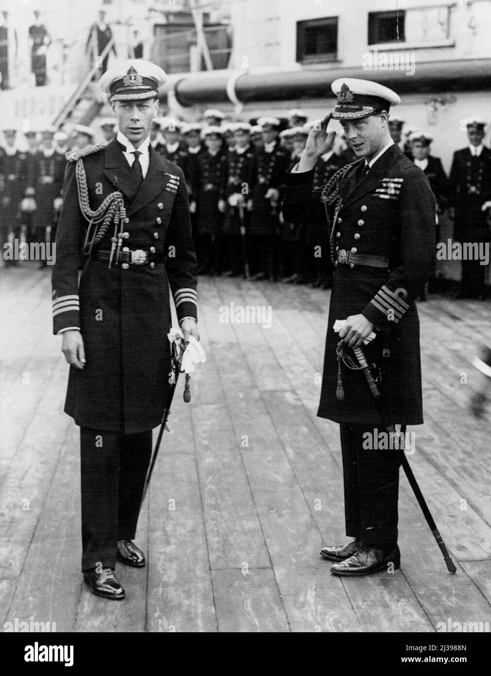 A picture taken aboard the quarter deck of the battleship Renown at Plymouth, showing the Prince of Wales (later King Edward VIII) - at right - saluting, and his brother, the Duke of York, now King George VI. Pictured was in connection with the Prince of Wale's tour of Japan and the East. June 21, 1922. (Photo by Reuterphoto). Stock Photo
