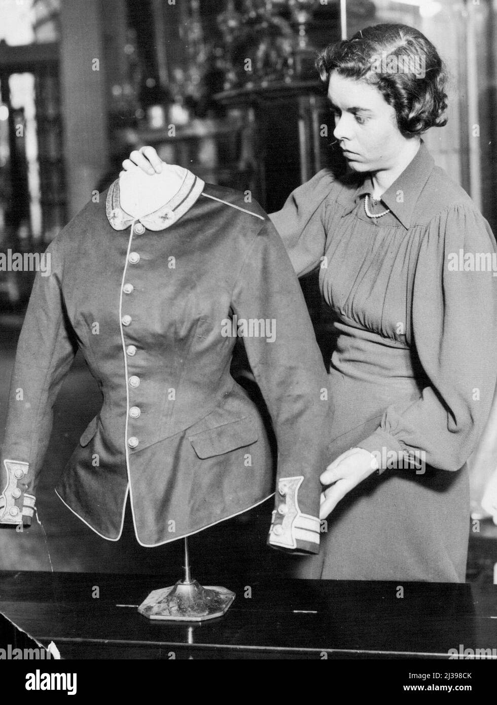 Royal treasures exhibition in aid of the Westminster hospital rebuilding fund, at great Stanhope street, Park Lane - The Queen has lent a military tunic which was always worn by Queen Victoria when she received troops. It is an exact replica, in scarlet cloth, of the military uniforms of the time. April 8, 1937. (Photo by Sport & General Press Agency Limited). Stock Photo