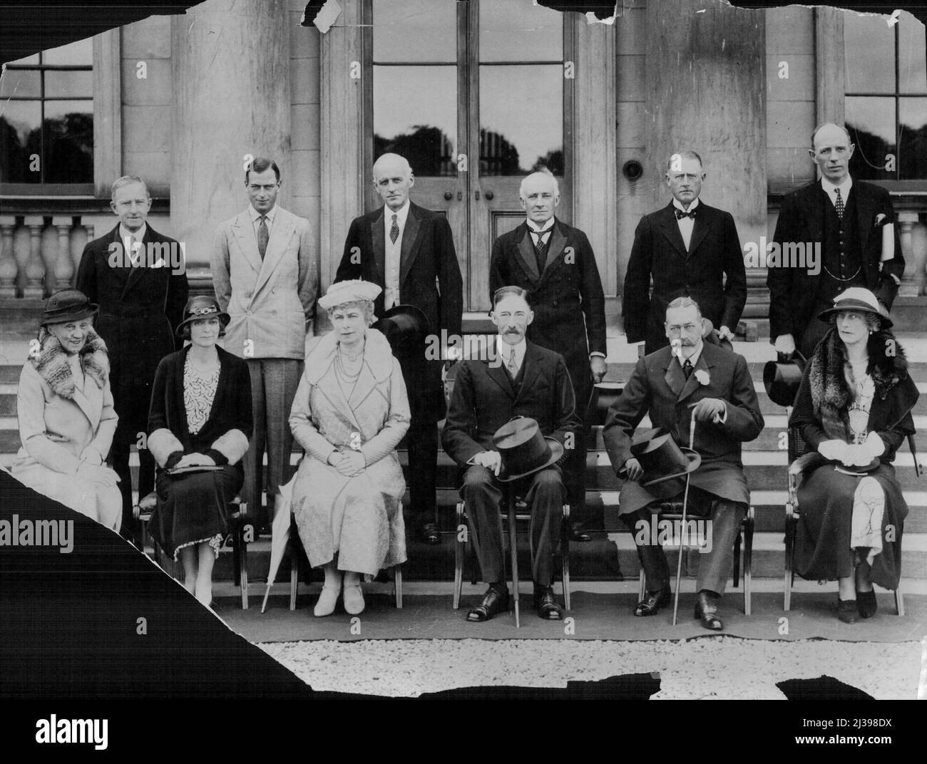 Exclusive Photograph Of Royal House Party At Harewood House, Yorkshire. An exclusive and official photograph taken at Harewood house, during the recent royal visit to Yorkshire. Back Row- left to right - Sir B. Godfrey Faussett, Prince George, Mr. Mitchell (secretary), Sir E. Milton young (Minister in attendance), Sir Guy Graham and Lord Irwin. Front row- left to right- Lady Bertha Dawkins, (Lady-in-waiting), Lady Irwin, H.R.H. Queen Mary, Lord Harewood, H.R.H. King George, and Lady Graham. August 26, 1933. (Photo by Topical Press). Stock Photo