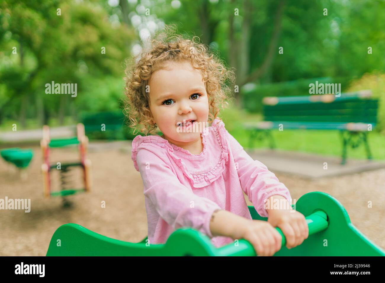 Happy little girl is playground having fun Stock Photo - Alamy