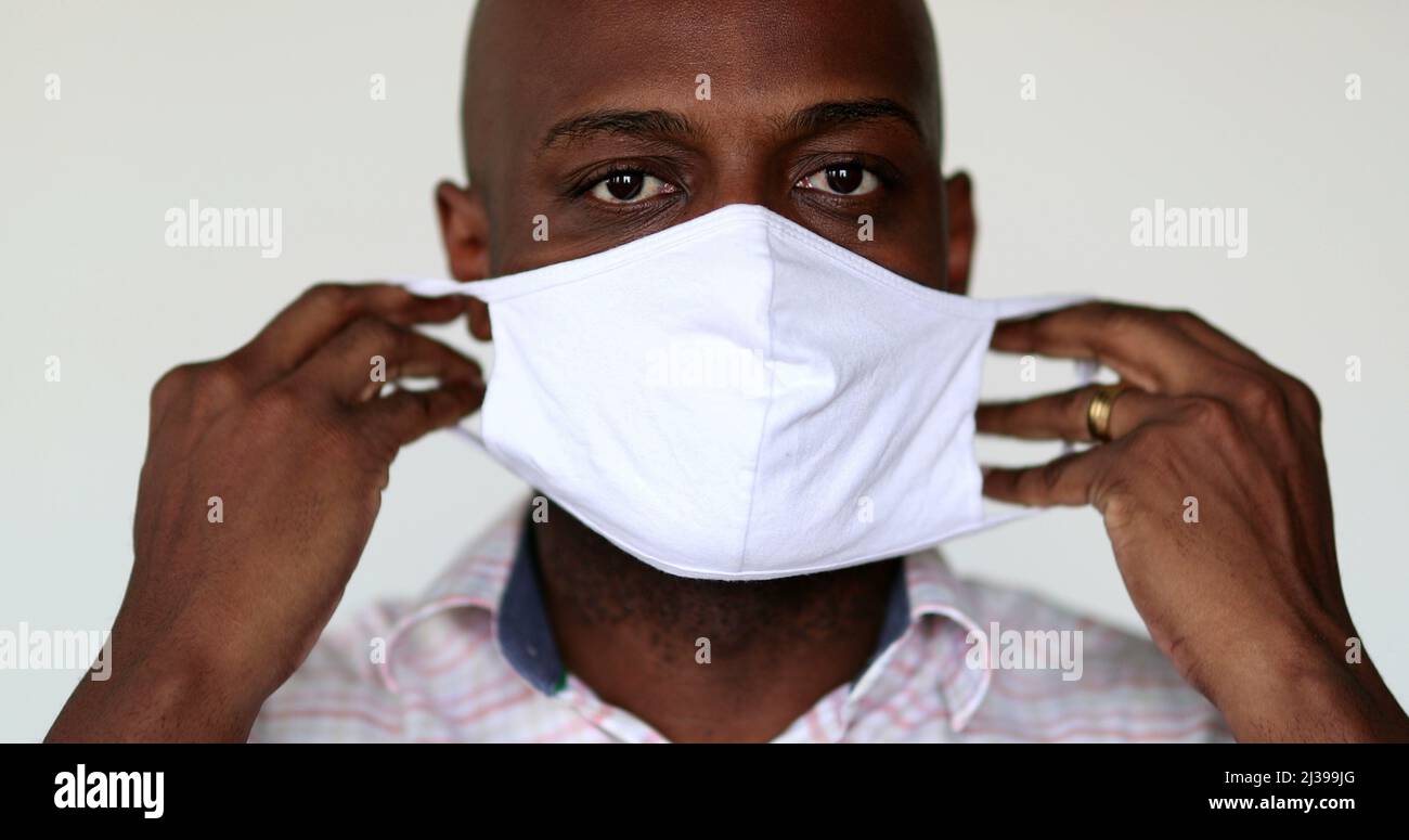African man wearing covid19 face mask, portrait black guy putting face mask Stock Photo Alamy