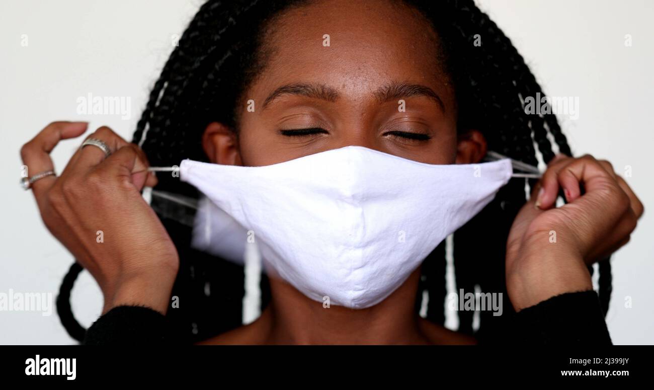African teen girl removing face mask in relief. Person takes off mask Stock Photo Alamy