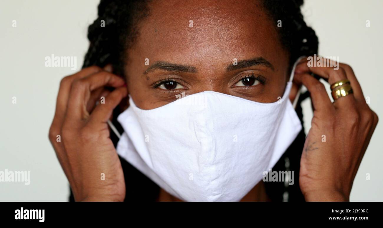 African woman putting face mask hi-res stock photography and images - Alamy