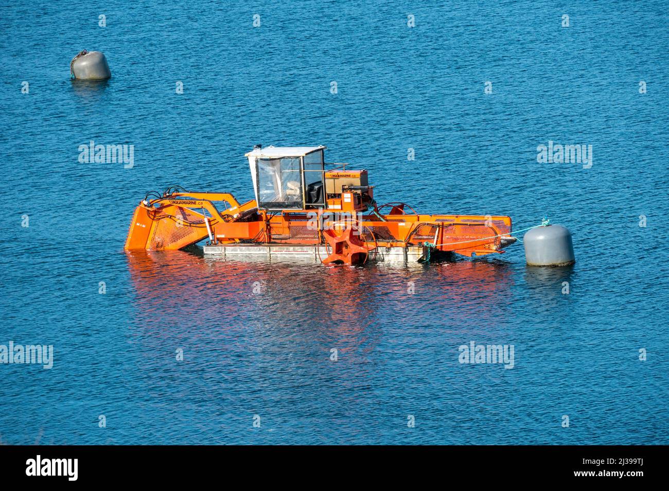 Aquamarine Model H5-200 Aquatic Weed Harvester moored in Loch Tarbert on the Isle of Harris, Scotland, UK Stock Photo