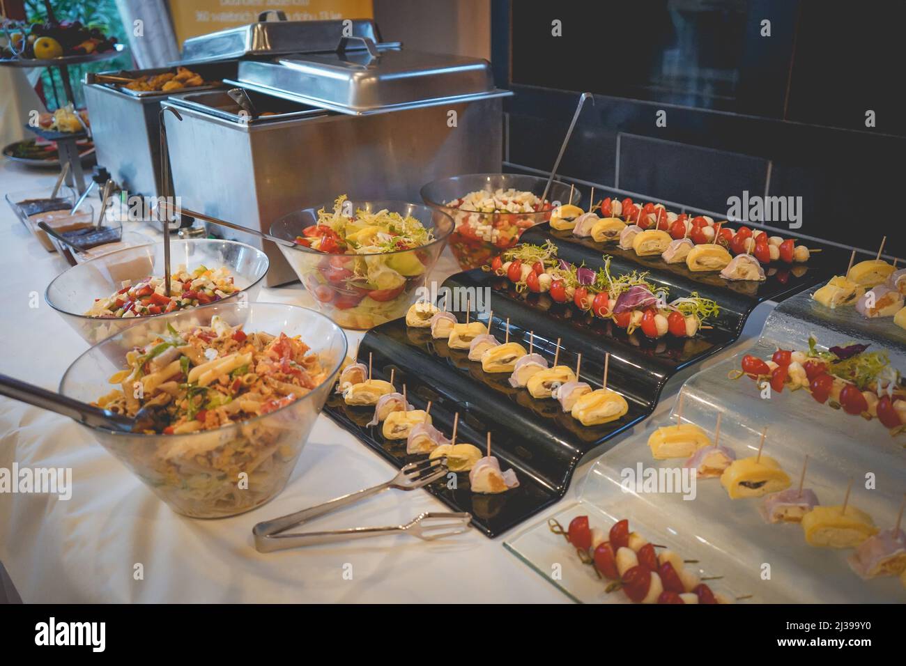 A closeup of a buffet reception table with delicious small appetizers
