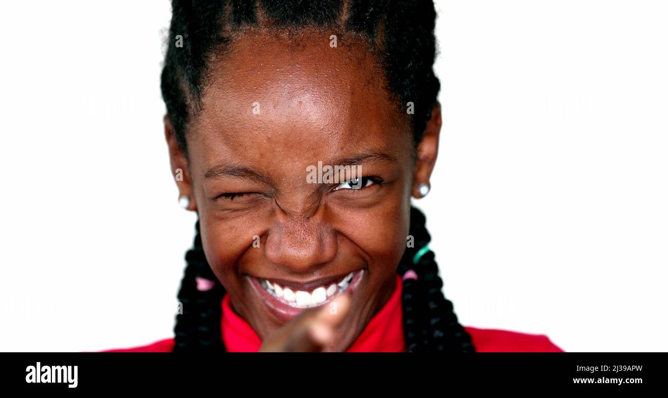 Happy black teen girl smiling at camera winking Stock Photo - Alamy