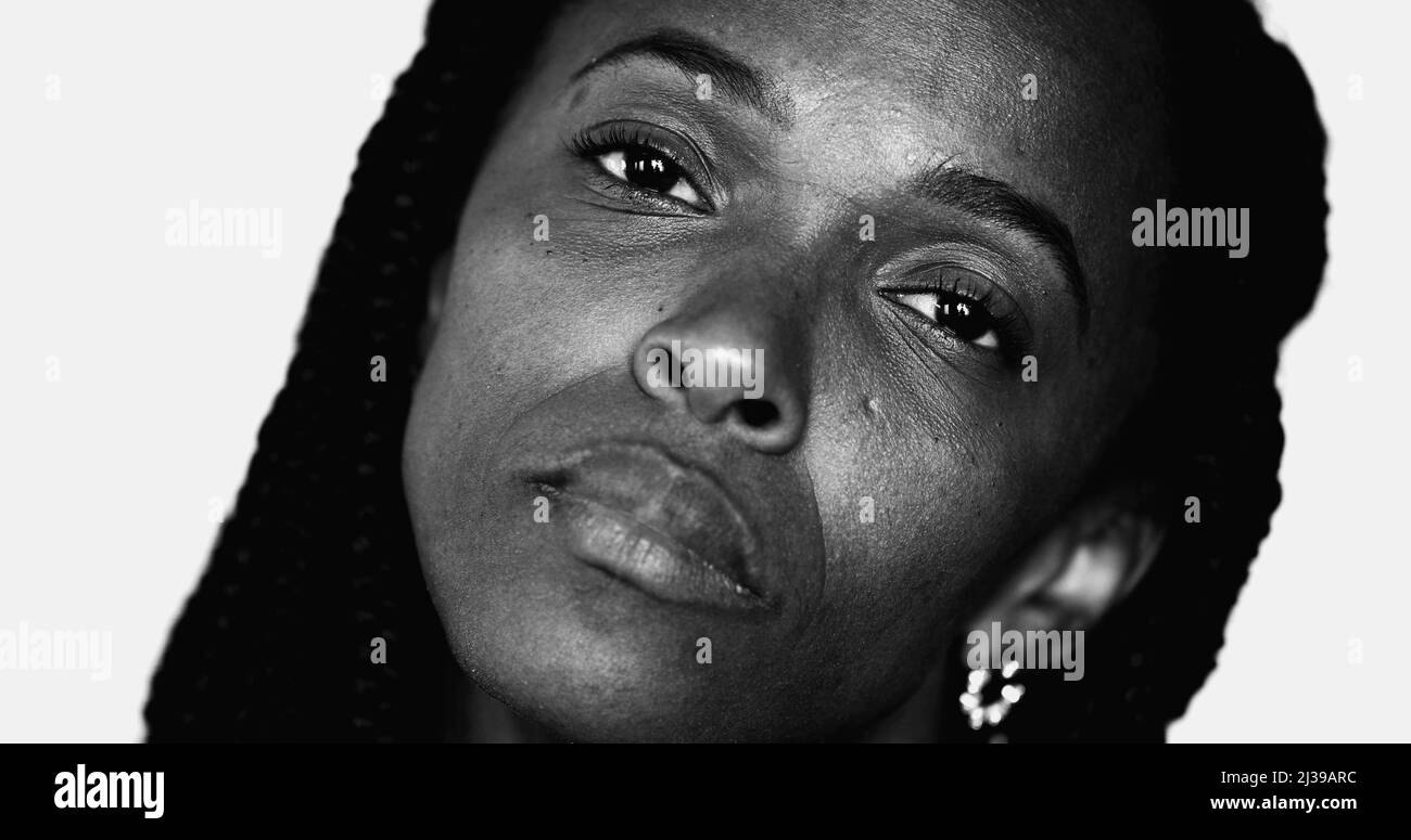 Monochrome portrait of serious African black woman looking at camera close-up face Stock Photo