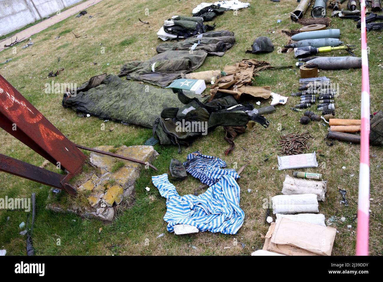 BUCHA, UKRAINE - APRIL 5, 2022 - Clothes and ammunition of Russian invaders are arranged on the ground in liberated Bucha, Kyiv Region, northern Ukrai Stock Photo