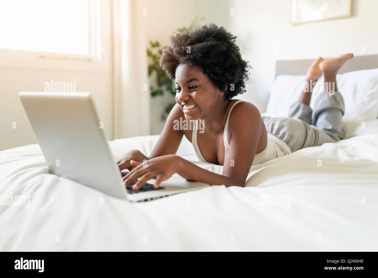 Young black woman using hi-res stock photography and images - Alamy