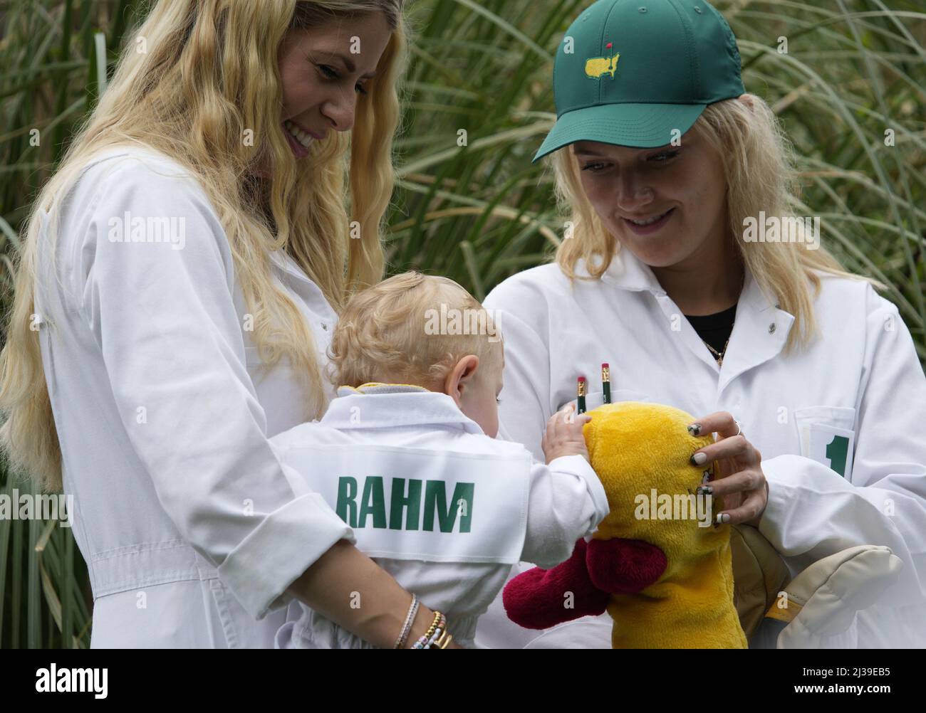 Augusta, United States. 06th Apr, 2022. Kelley Rahm, wife Jon Rahm of Spain, (L) and Clare Fleetwood, wife of England's Tommy Fleetwood, watch as Rahm's son Kepa plays with a club cover during the Par 3 Contest at the Masters golf tournament at Augusta National Golf Club in Augusta, Georgia on Wednesday, April 6, 2022. Photo by Bob Strong/UPI Credit: UPI/Alamy Live News Stock Photo