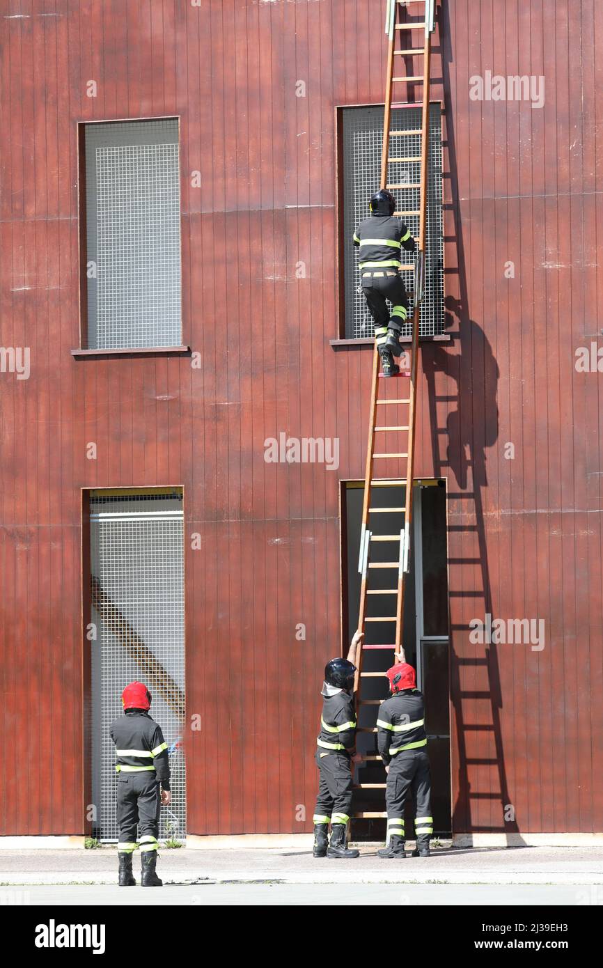 Firefighters climb ladder hires stock photography and images Alamy