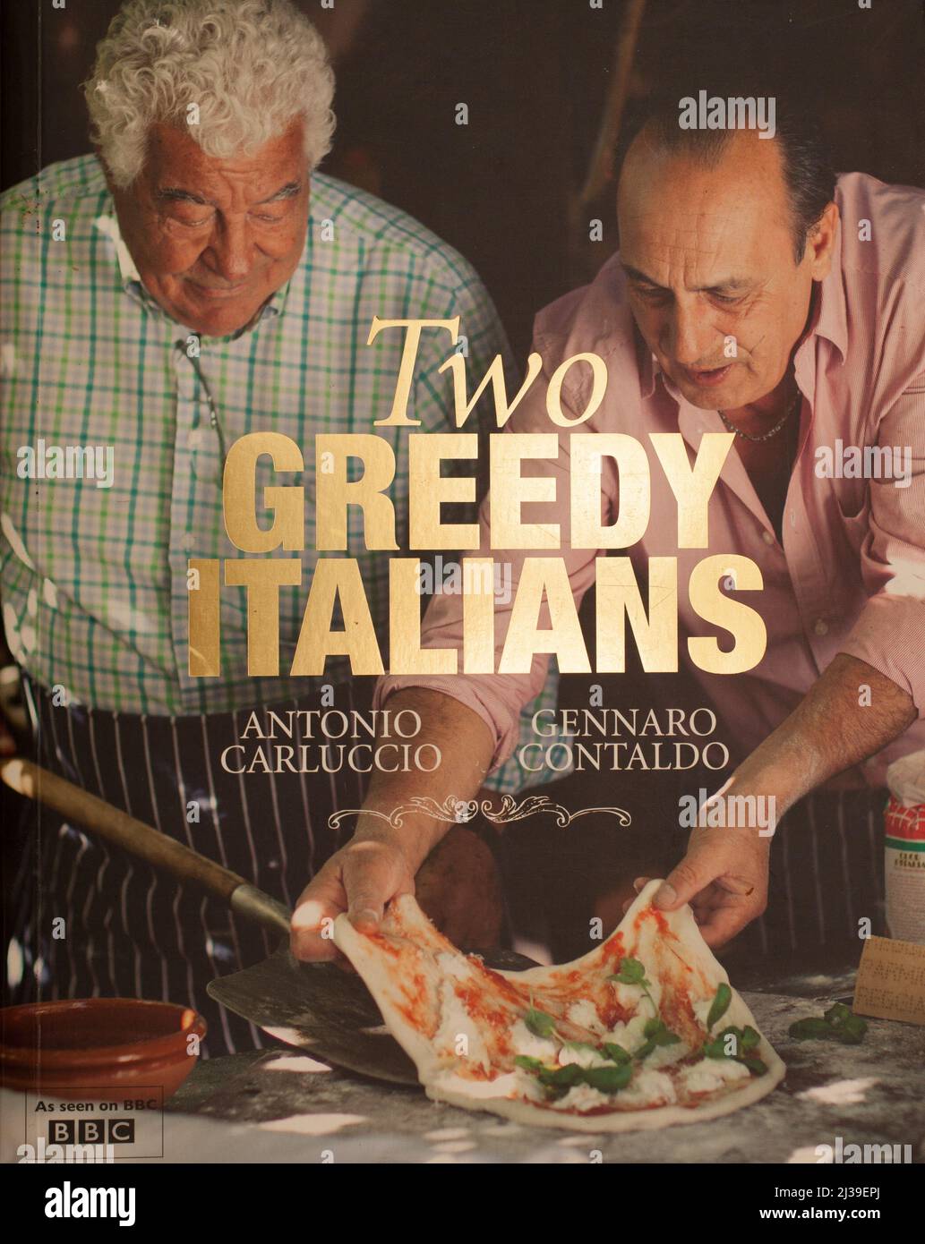 The book, Two Greedy Italians by Antonio Carluccio and Gennaro Contaldo Stock Photo