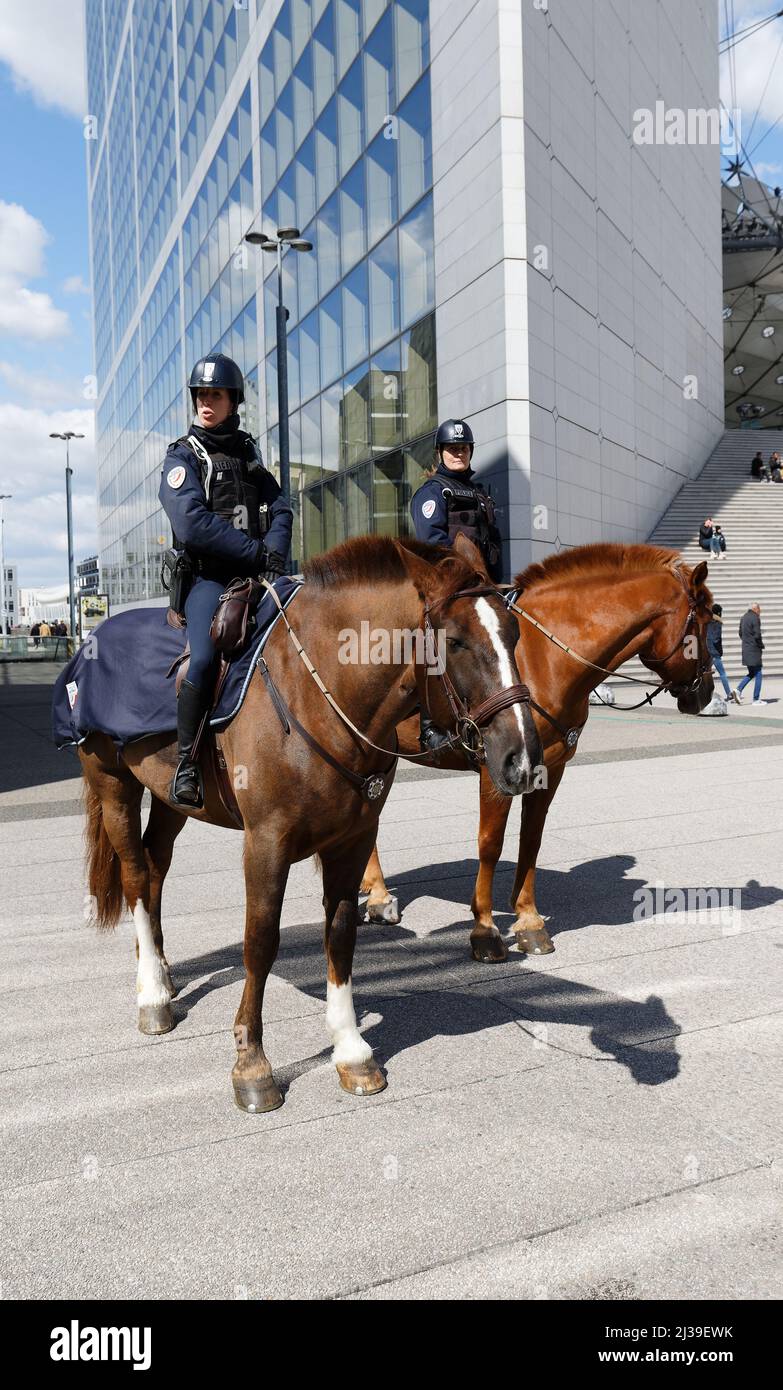 Two mounted police officers on horses are patrolling through the walkway of the seine river in downtown of Paris Stock Photo
