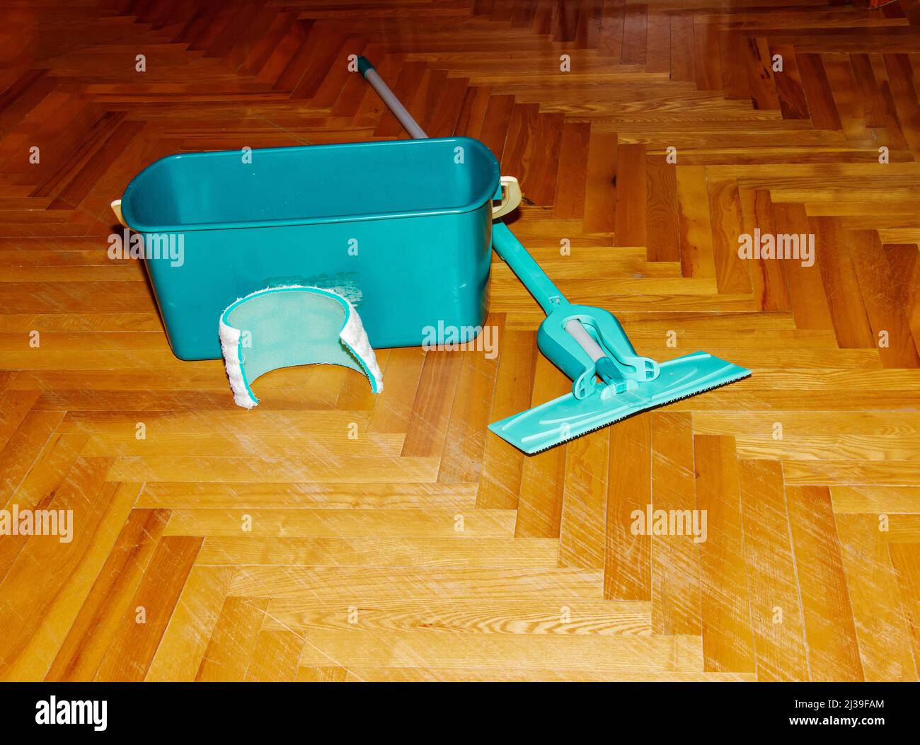 Mop your wood floor. A bucket with a special solution for washing