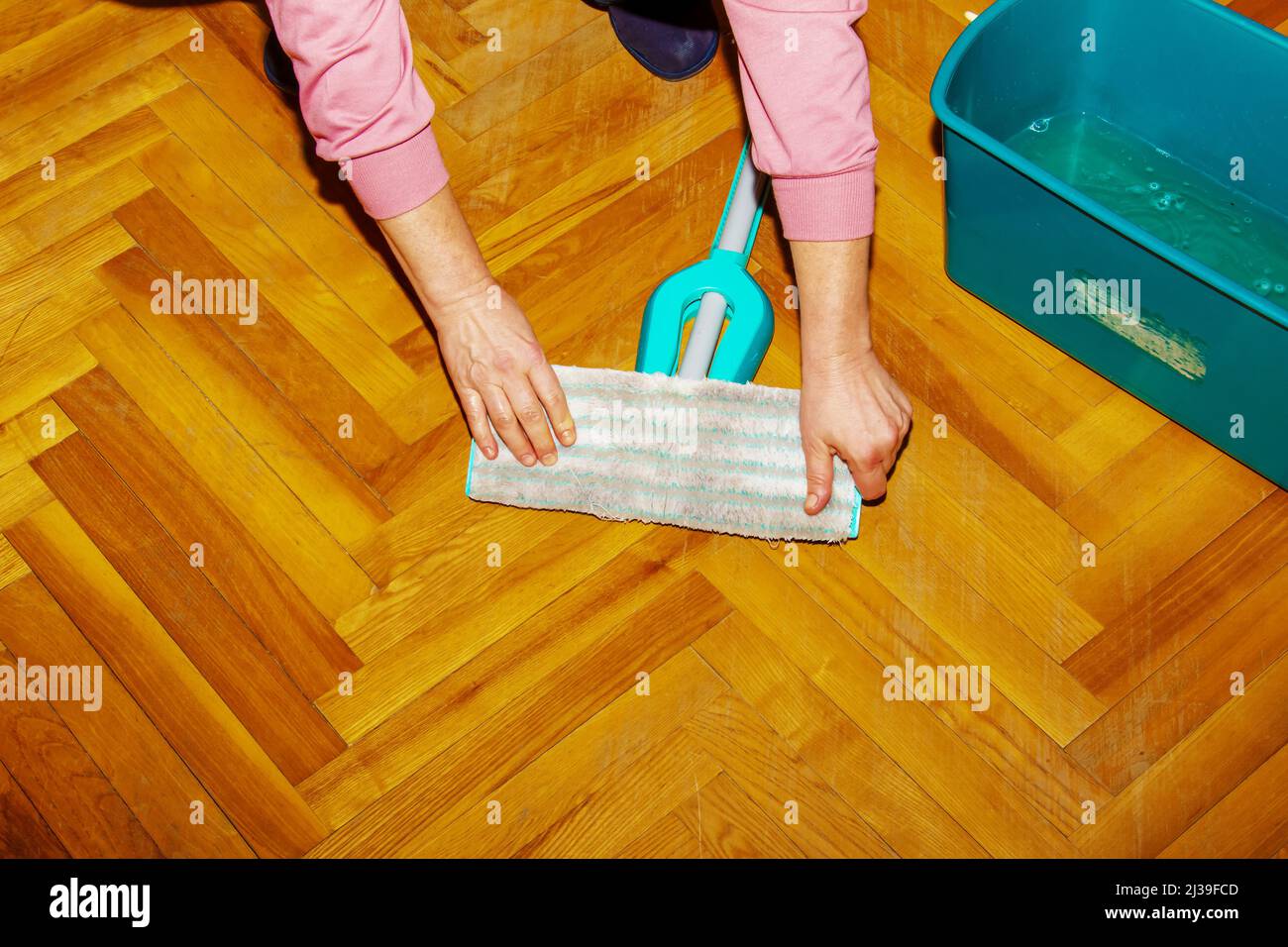 Mop your wood floor. A woman prepares a mop. Housekeeping concept Stock