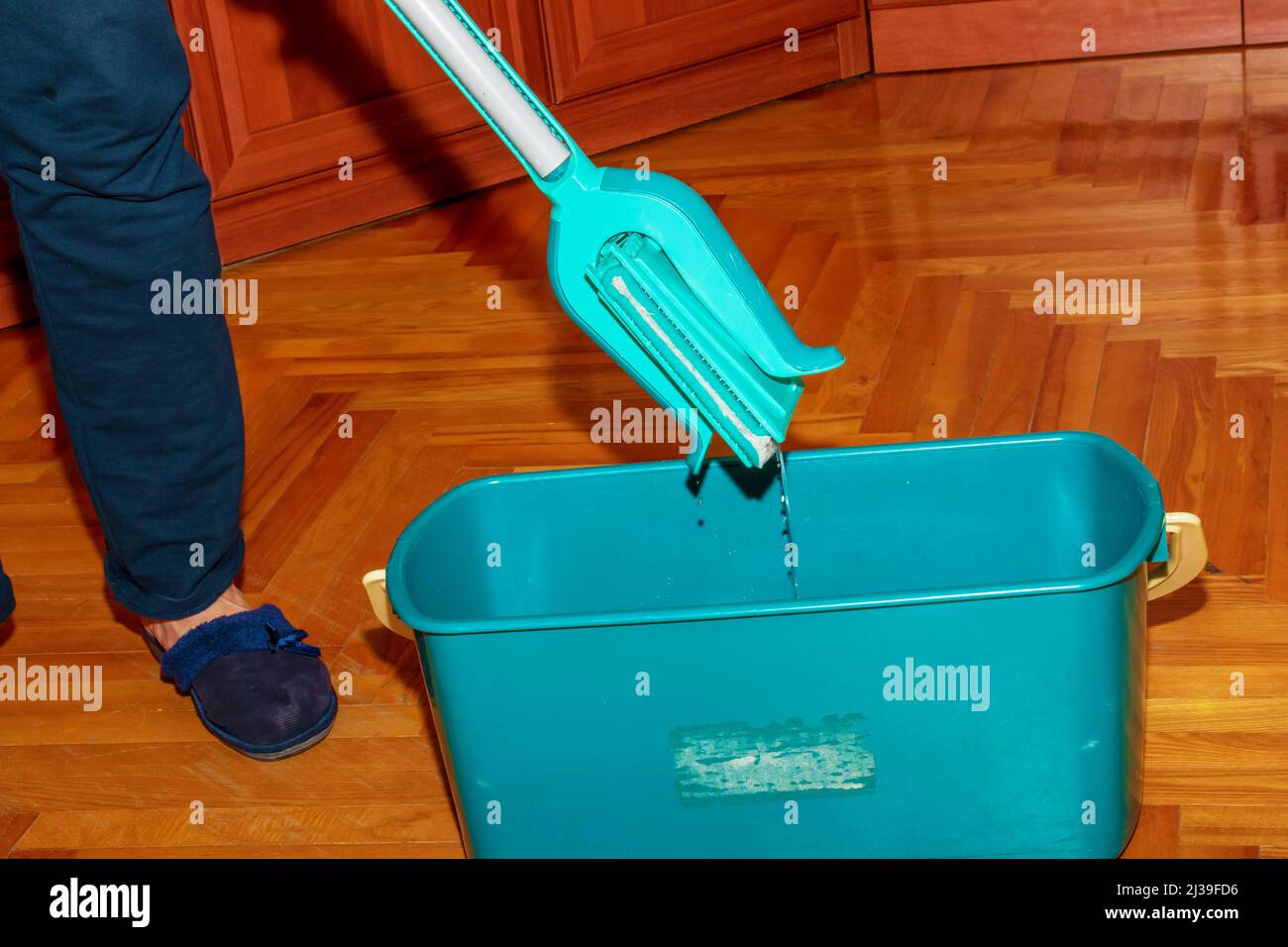 Mop your wood floor. A woman prepares a mop. Housekeeping concept Stock