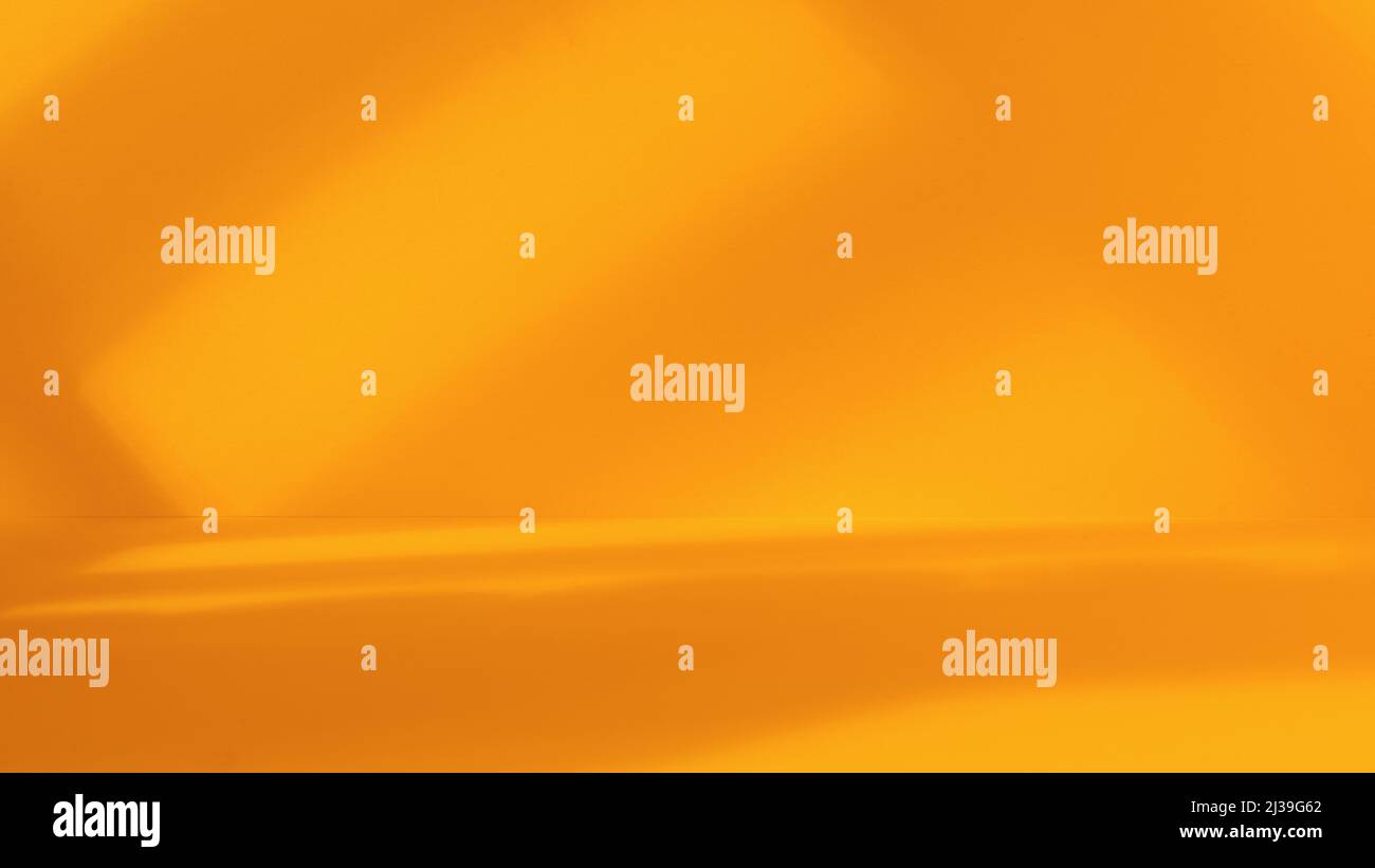 Empty yellow studio space with artistic windows shadow. Minimalistic space concept Stock Photo