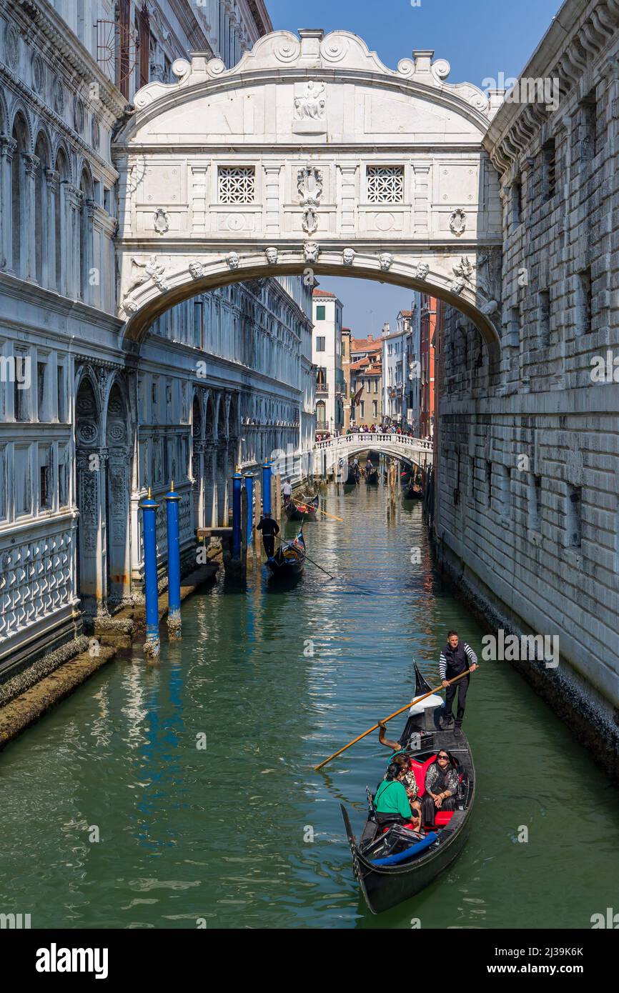 VENICE, ITALY - MARCH 27 2022: A gondola passes under the famous 'Bridge of Sighs' at the Doge's Palace in the Italian city of Venice Stock Photo