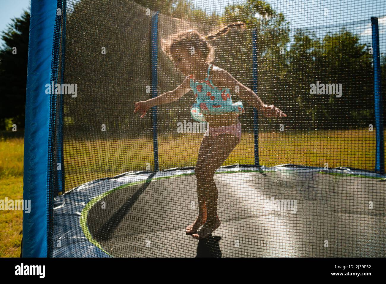 Young Girl With Braids Jumping On Trampoline Stock Photo - Alamy