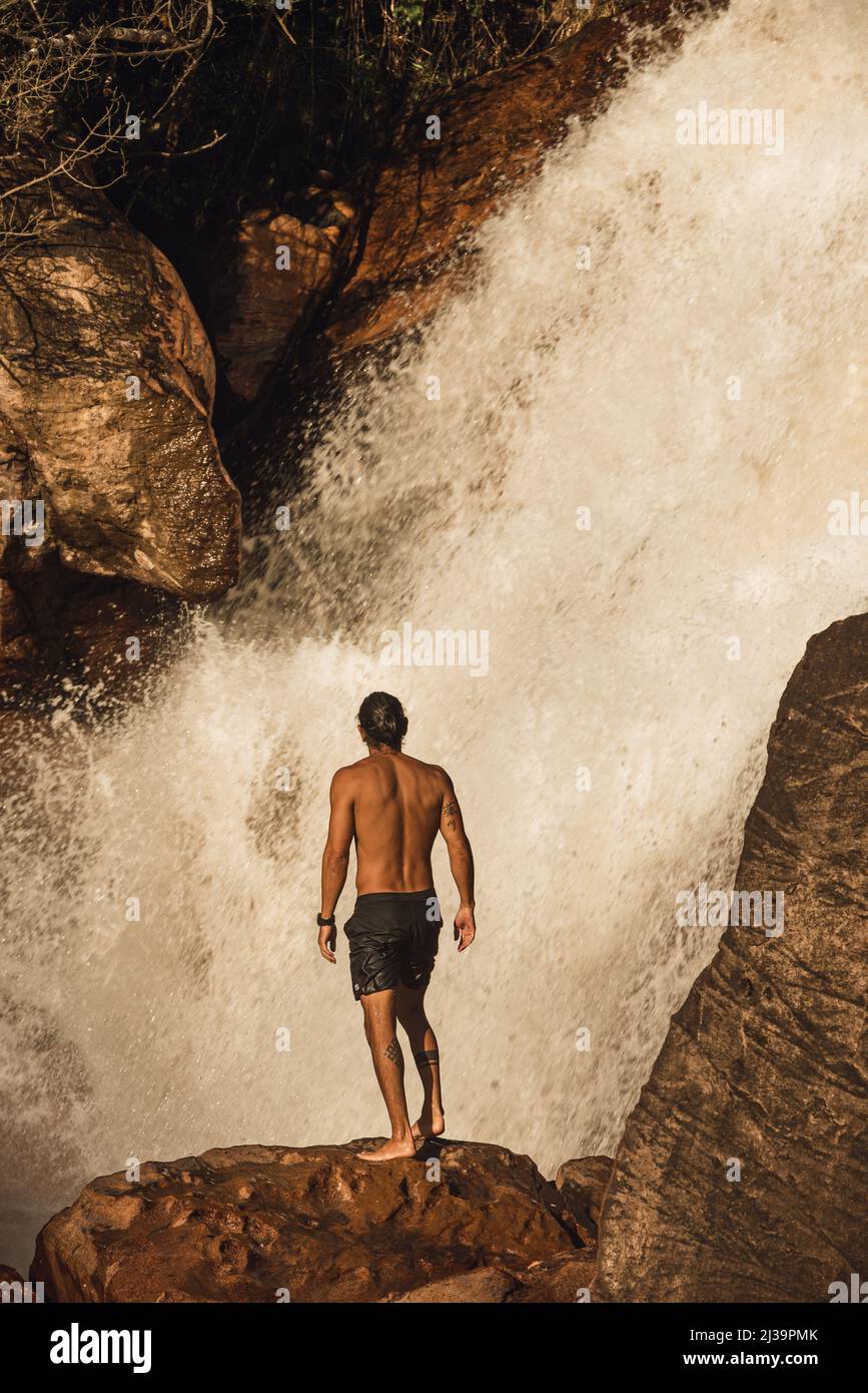 Healthy man climbing rocks on a waterfall Stock Photo Alamy