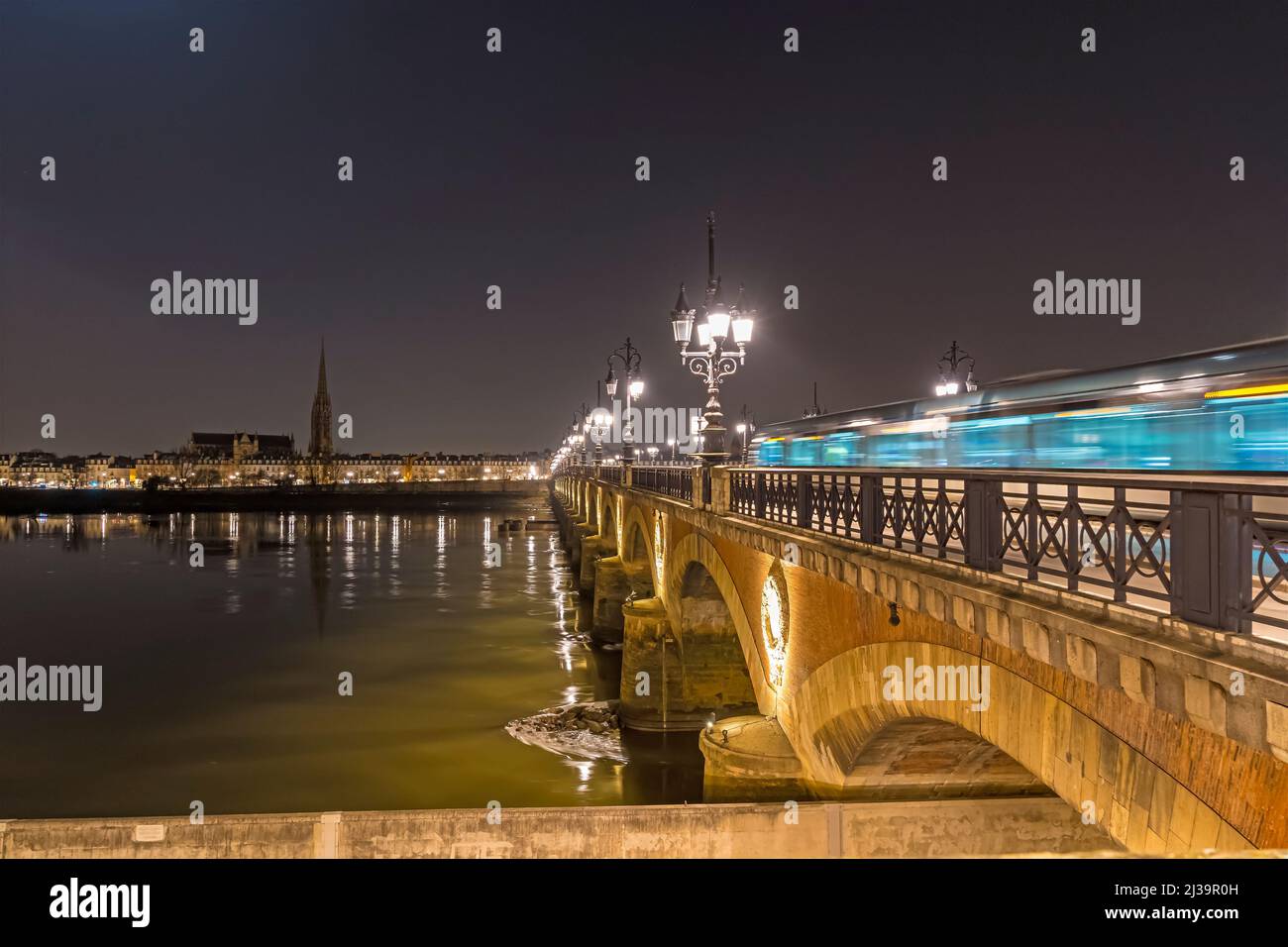 Stone Bridge Empty and Enlightened at Night in Bordeaux With Garonne Stock Photo