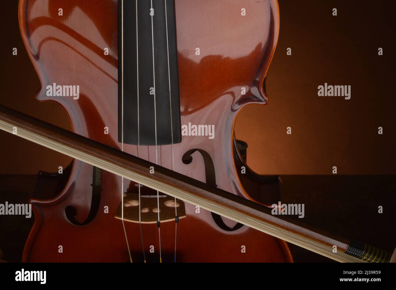 Close up of violin, bow, bridge, 'F holes' and finger board Stock Photo