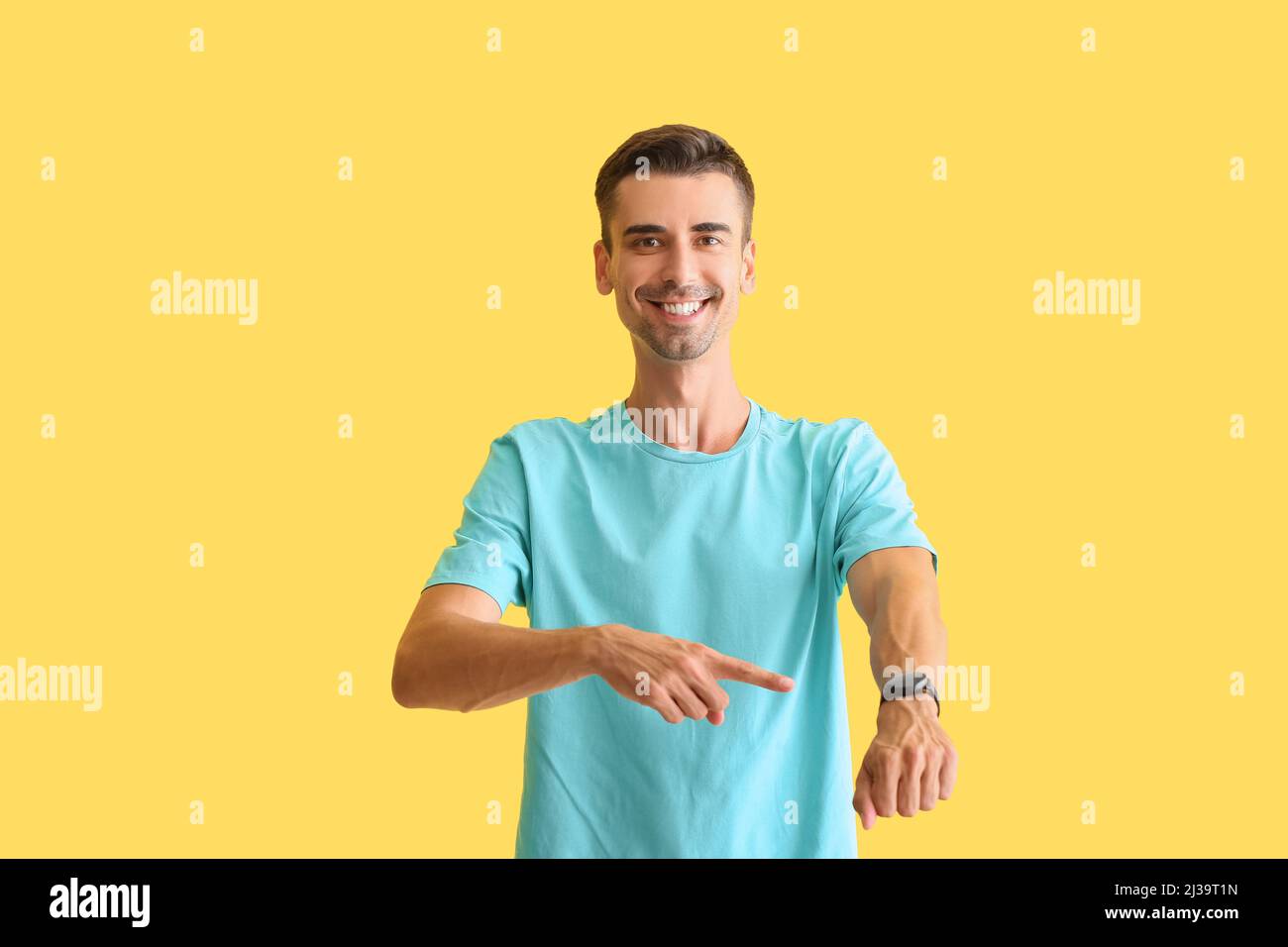 Handsome man with smartwatch on color background Stock Photo