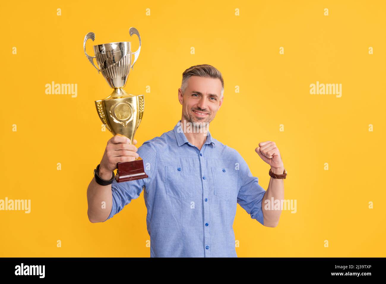happy successful man hold golden cup, motivation Stock Photo