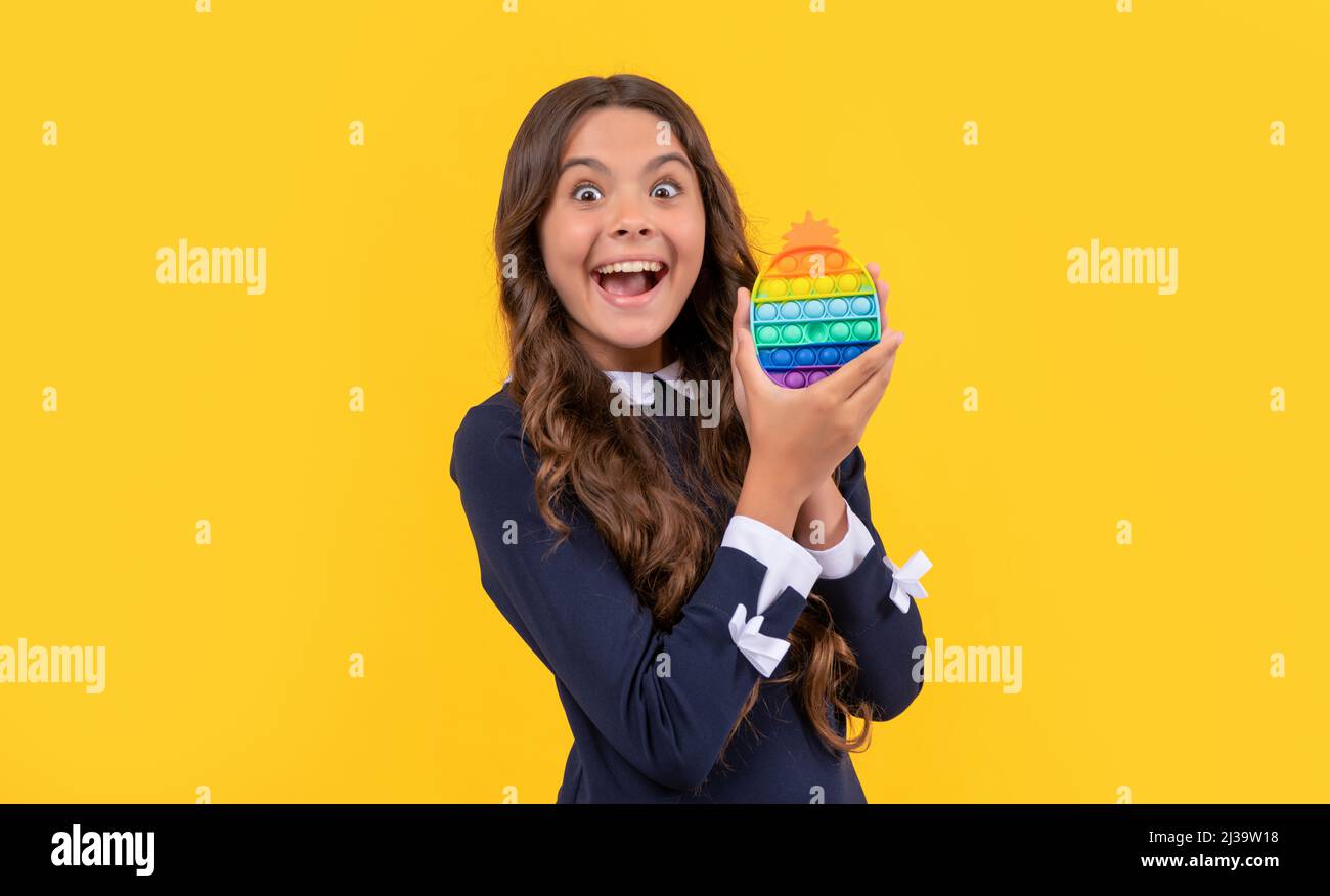 amazed teen girl play with pop it silicone sensory fidget game, childhood Stock Photo