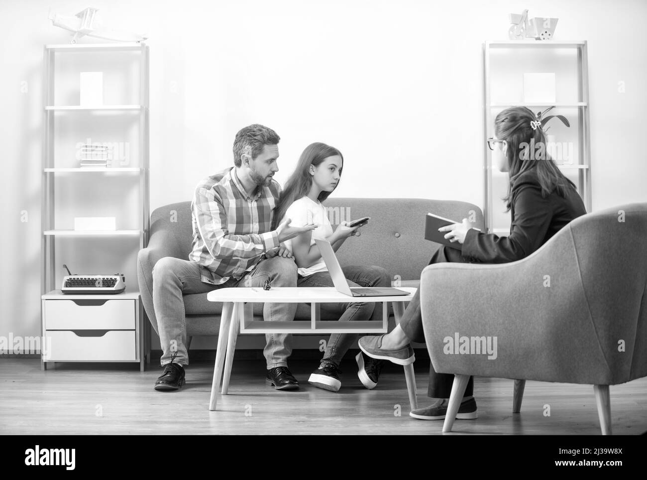 life coach. phone addiction. father and child at psychologist session. family therapy Stock