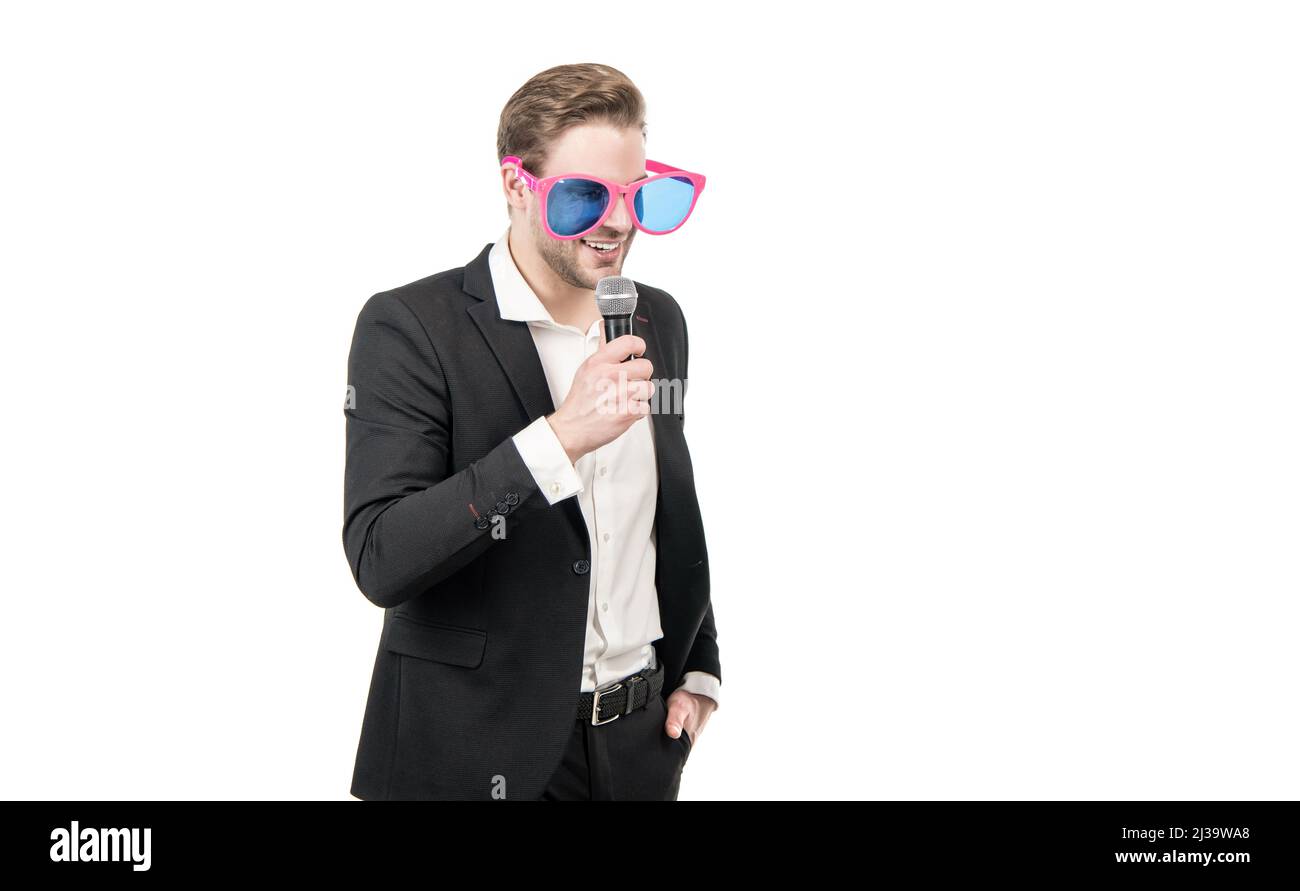 Speaking in public. Speaker in funny glasses speak to microphone. Business speaker isolated on white Stock Photo