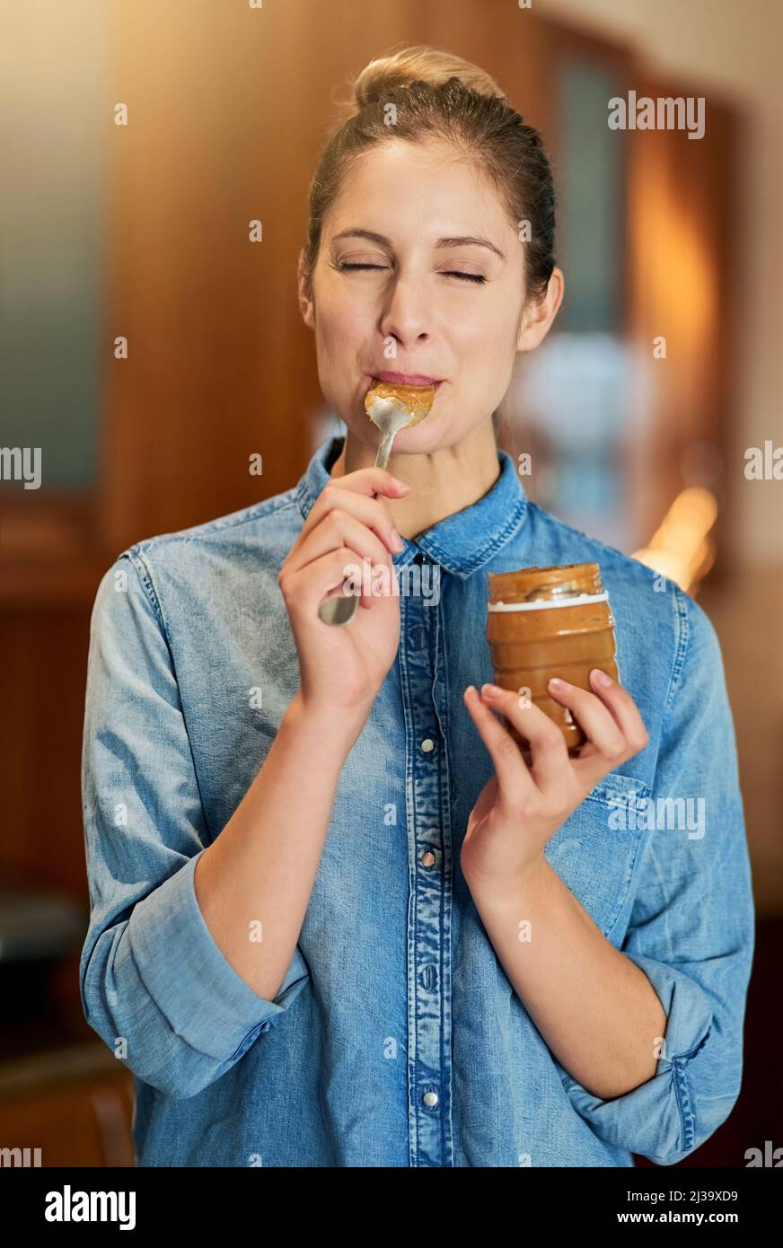 Savouring a spoonful of joy. Cropped shot of a young woman eating