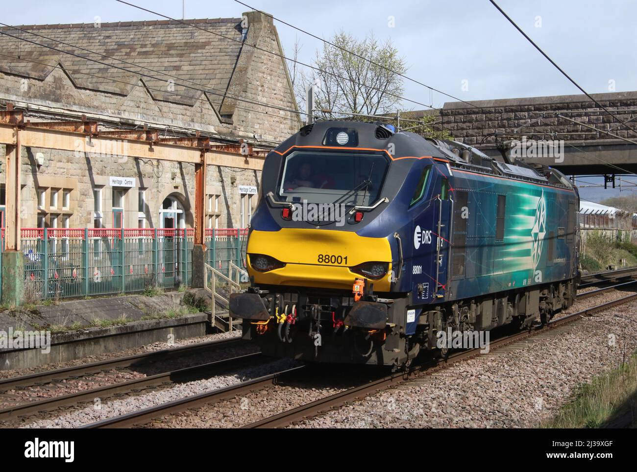 DRS class 88 Bi-Mode Electro-diesel loco, number 88001 named Revolution, passing through Carnforth on the WCML on Wednesday 6th April 2022. Stock Photo